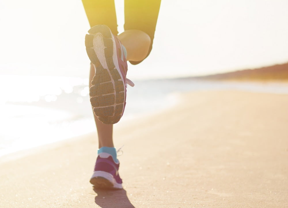 a lady chiropractor jogging near by the beach